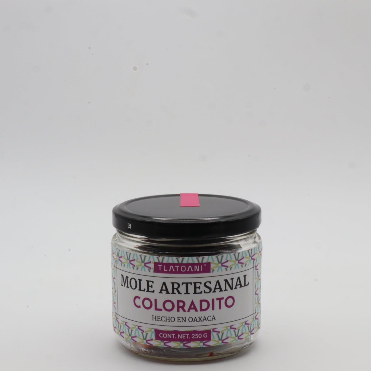 Frasco de mole artesanal coloradito Tlatoani de 250g, hecho en Oaxaca, con tapa negra y etiqueta color magenta sobre fondo blanco.